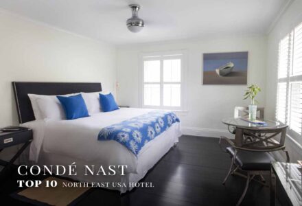 B&B room with blue pillows and comfy bed with Condé Nast Top 10 USA Hotels North East award overlay