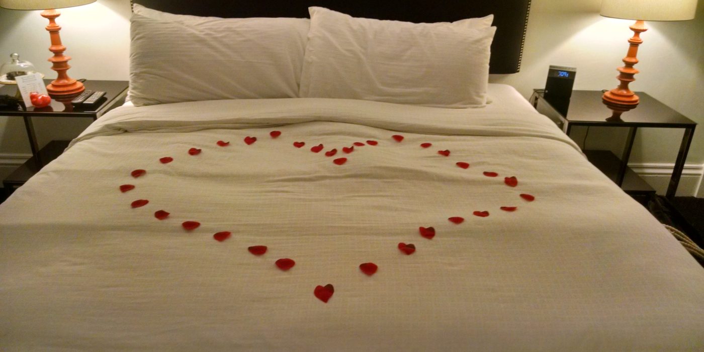 Flowers In Heart Shape On Bed